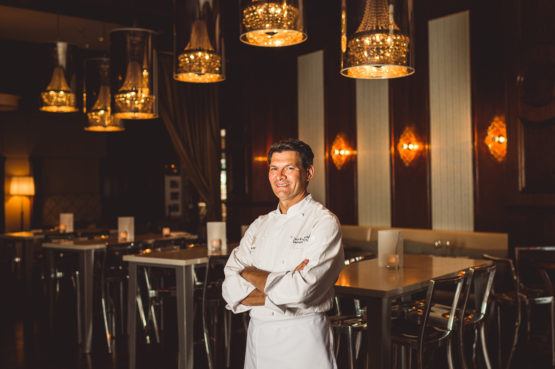 Chef Standing Infront of Dining Table