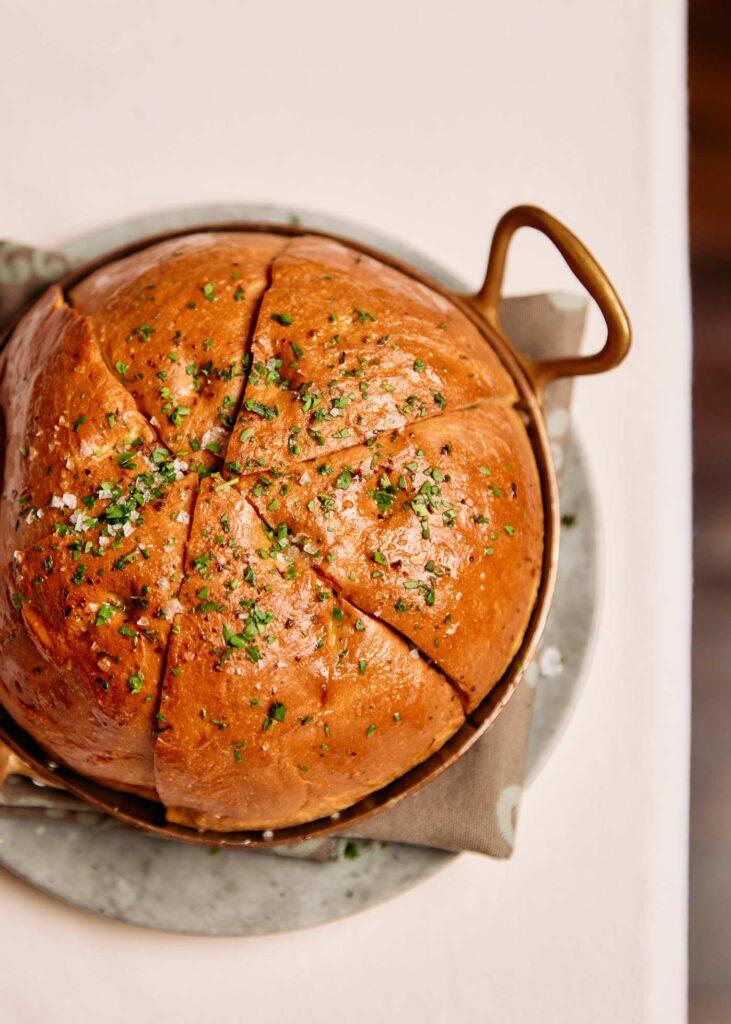 circular bread in a pot cut into 6 wedges