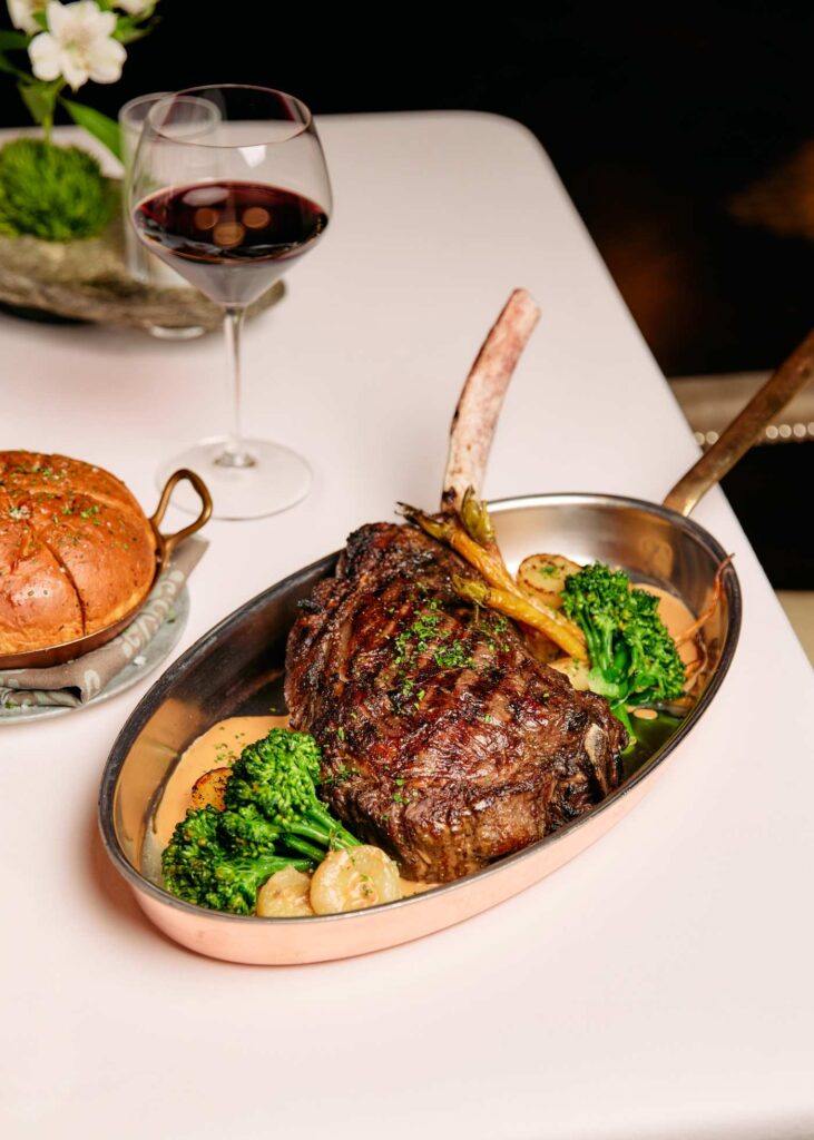 tomahawk steak served in a pan