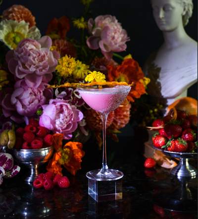a table topped with a martini glass filled with liquid